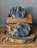 Decorative stone sculpture with a keychain on a wooden surface Handcrafted Smoky Raven mini worry stone, small gemstone palm stone"