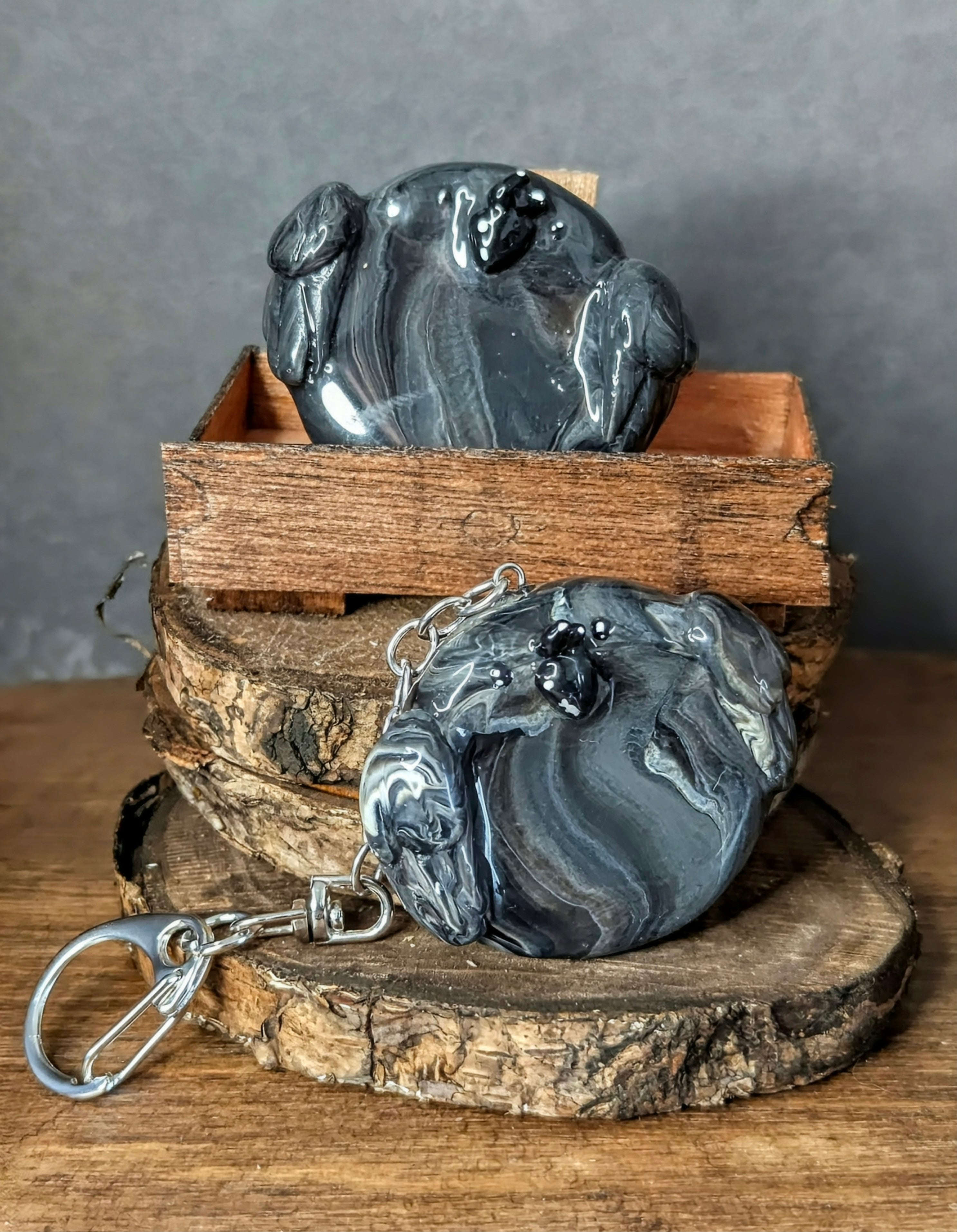 Decorative stone sculpture with a keychain on a wooden surface Handcrafted Smoky Raven mini worry stone, small gemstone palm stone"